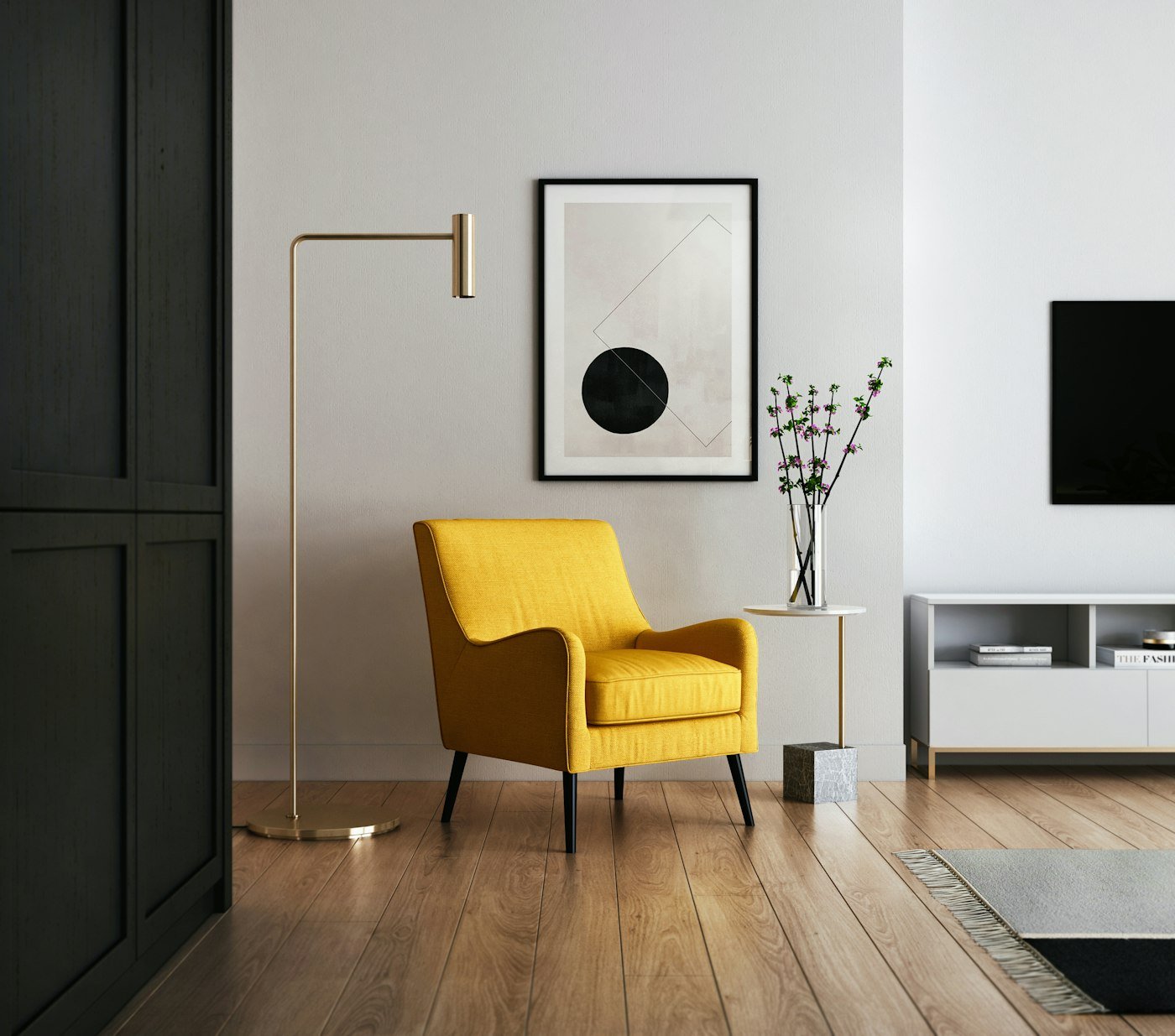 A yellow armchair, a brass floor lamp, and a framed print on a pale wall